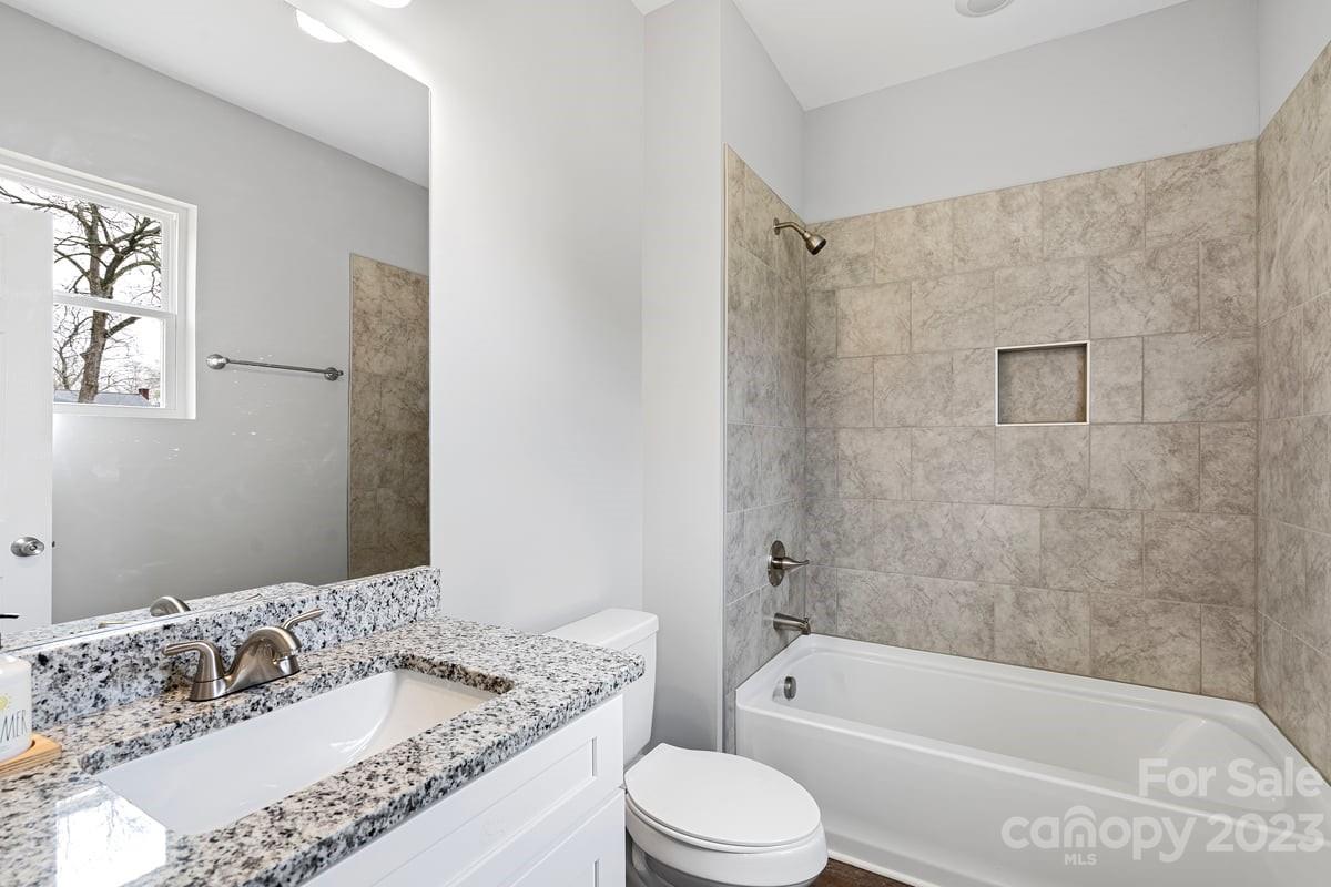 422 Queens Road Gastonia, NC 28052 - Photo 13 of 18 a bathroom with a granite countertop bathtub shower sink mirror and toilet