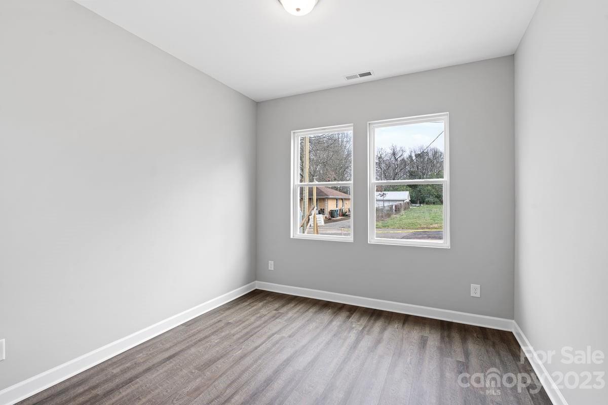 422 Queens Road Gastonia, NC 28052 - Photo 15 of 18 an empty room with wooden floor and windows