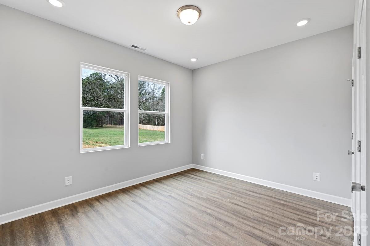 422 Queens Road Gastonia, NC 28052 - Photo 17 of 18 an empty room with wooden floor and windows