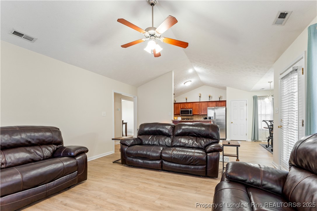 292 Falling Leaf Drive Raeford, NC 28376 - Photo 11 of 40 a living room with furniture a ceiling fan and a couch