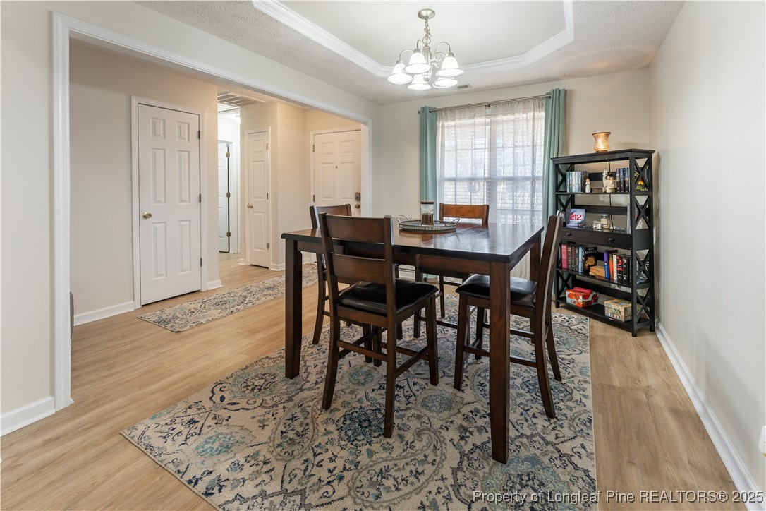 292 Falling Leaf Drive Raeford, NC 28376 - Photo 14 of 40 a view of a dining room with furniture window and wooden floor