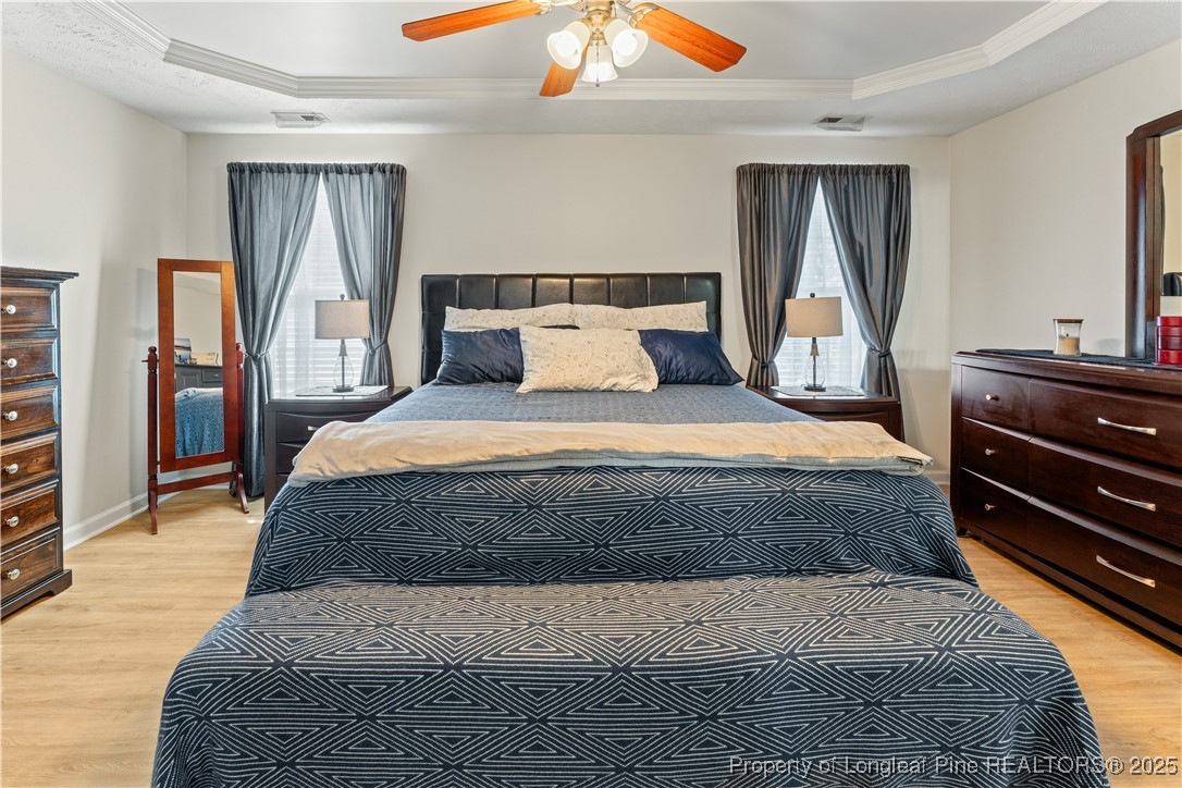 292 Falling Leaf Drive Raeford, NC 28376 - Photo 17 of 40 a bedroom with a large bed and a dresser