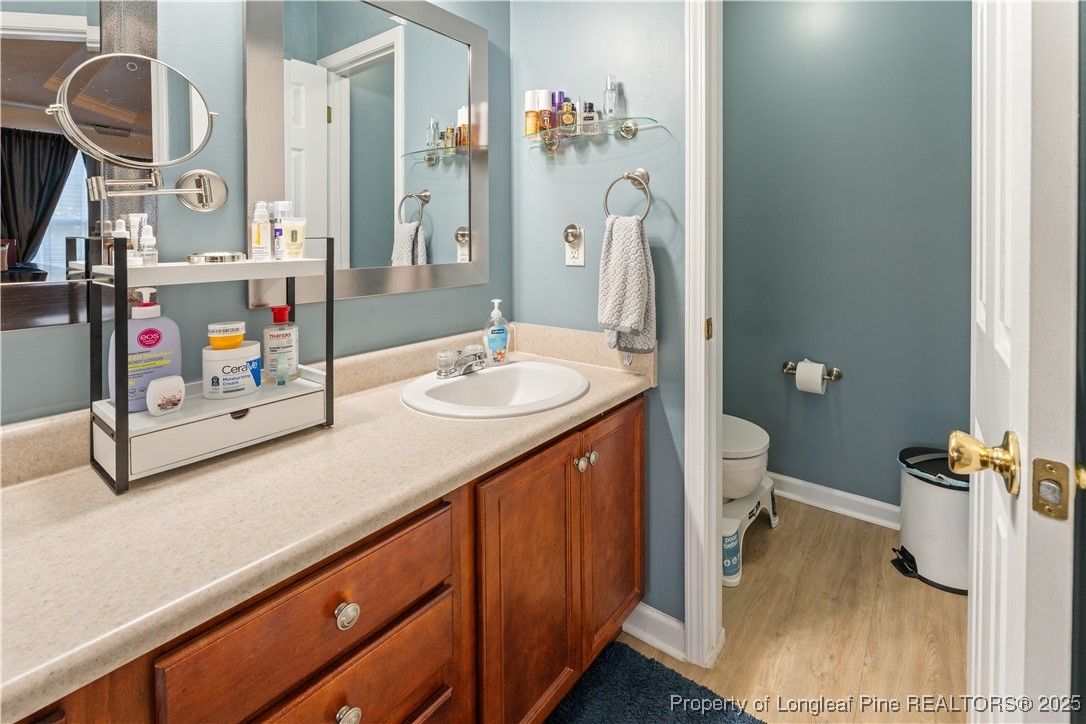 292 Falling Leaf Drive Raeford, NC 28376 - Photo 20 of 40 a bathroom with a sink double vanity and a toilet