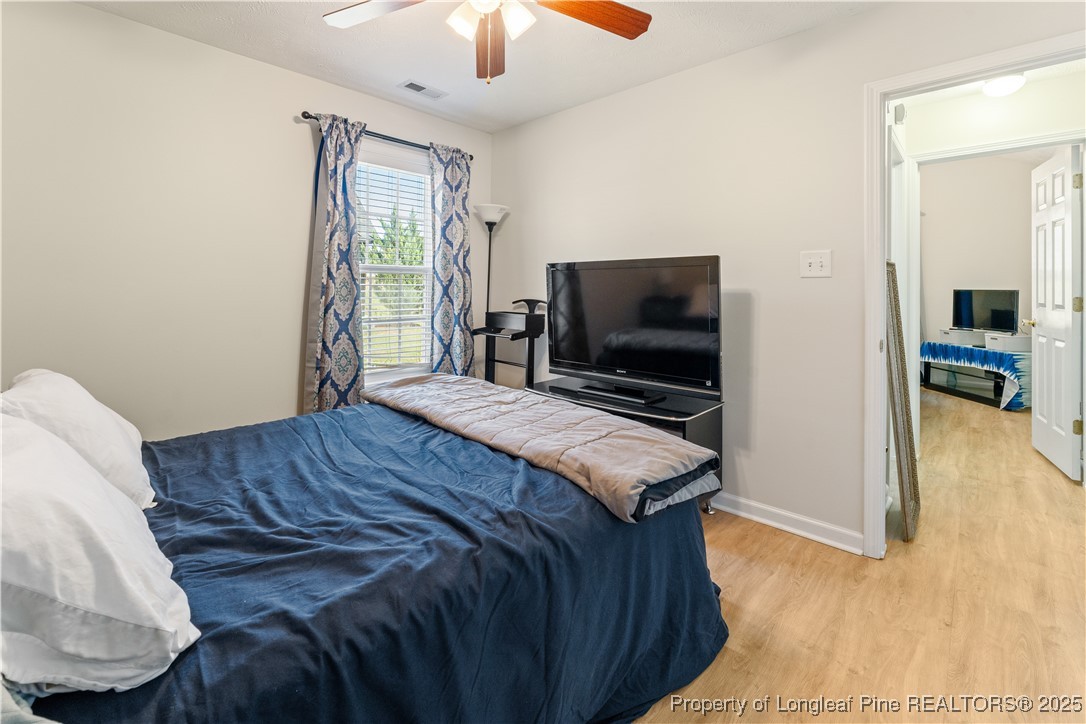 292 Falling Leaf Drive Raeford, NC 28376 - Photo 24 of 40 a bedroom with a bed and a flat screen tv