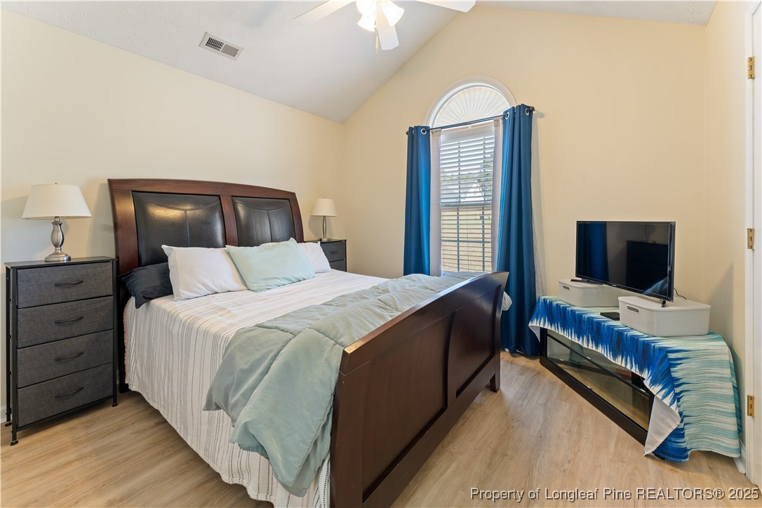292 Falling Leaf Drive Raeford, NC 28376 - Photo 25 of 40 a bedroom with a bed and a flat screen tv