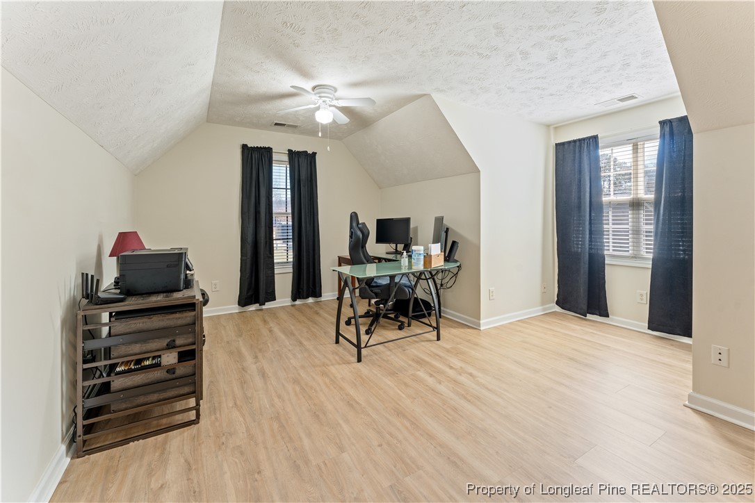292 Falling Leaf Drive Raeford, NC 28376 - Photo 27 of 40 a view of a livingroom with furniture and a flat screen tv