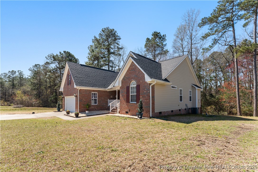 292 Falling Leaf Drive Raeford, NC 28376 - Photo 3 of 40 a view of a house with a yard covered in snow