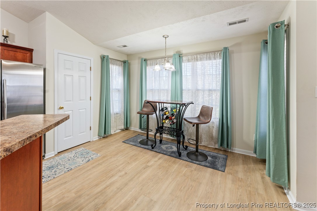 292 Falling Leaf Drive Raeford, NC 28376 - Photo 8 of 40 a view of a room with chairs and wooden floor