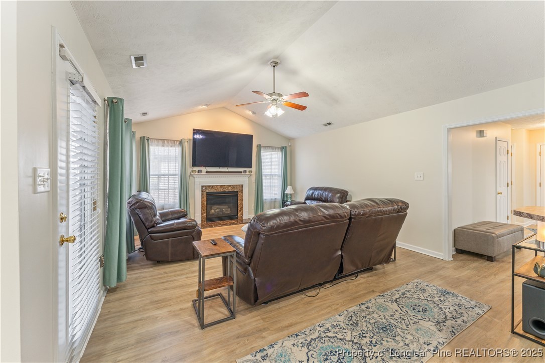 292 Falling Leaf Drive Raeford, NC 28376 - Photo 9 of 40 a living room with furniture and a fireplace
