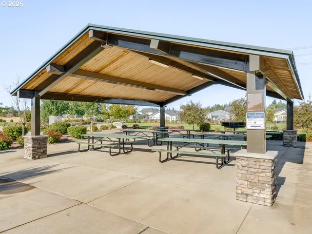 a view of a patio with a table and chairs under an umbrella