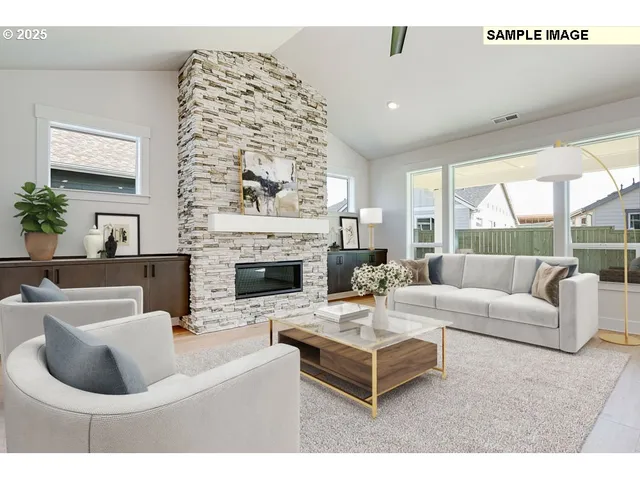 a living room with furniture a fireplace and a large window