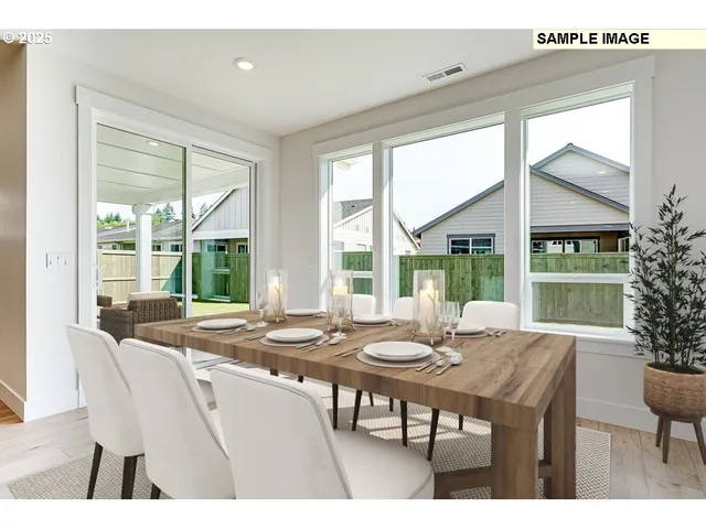 a view of a dining room with furniture large windows and wooden floor