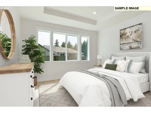 a bedroom with a large bed and a potted plant