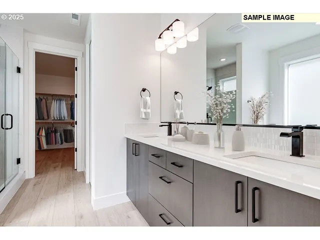 a bathroom with a sink double vanity and a mirror