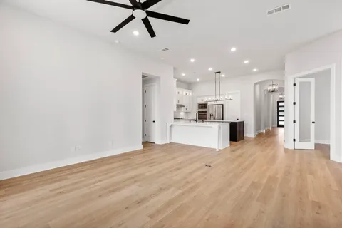 a view of a kitchen with a sink and refrigerator