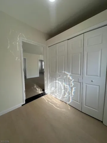 a view of an empty room with a fireplace