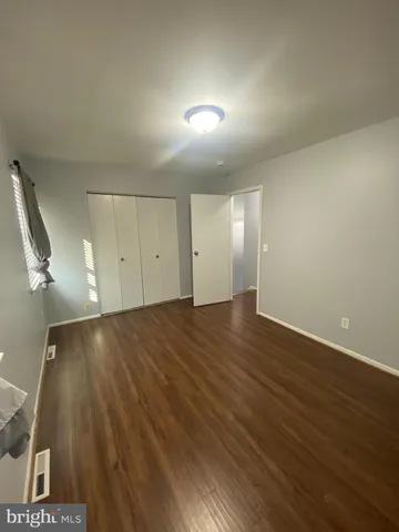 a view of an empty room and wooden floor