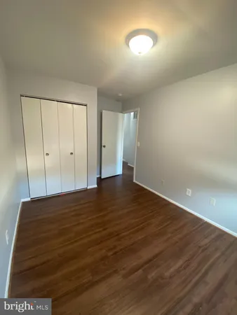 a view of an empty room and wooden floor
