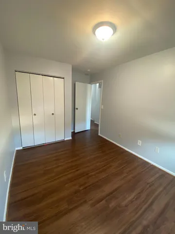 a view of an empty room and wooden floor