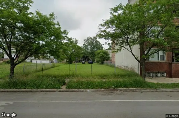 a view of a house with a yard and a street