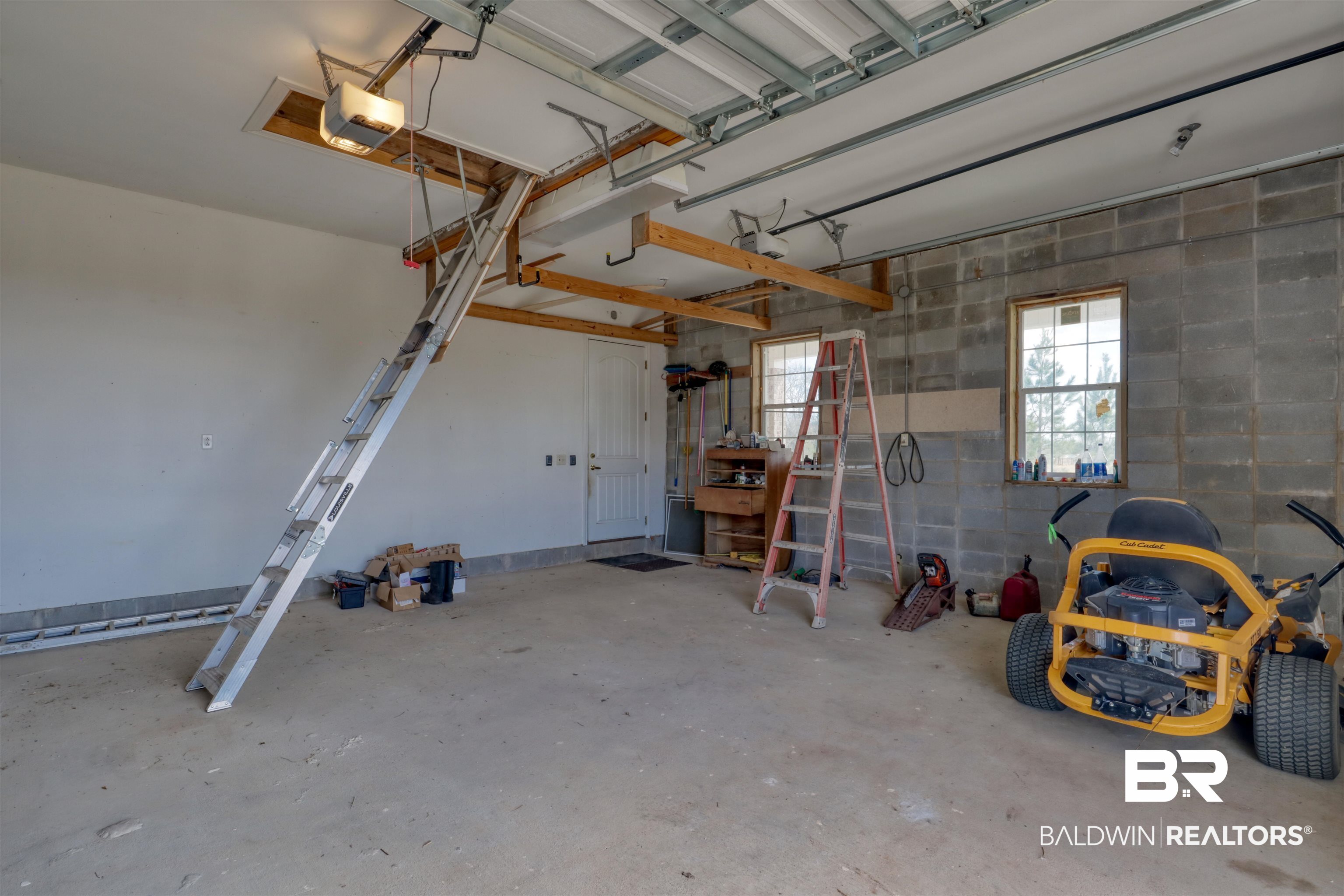 28461 Gardner Road Elberta, AL 36530 - Photo 31 of 46 Garage with concrete block wall and a garage door opener