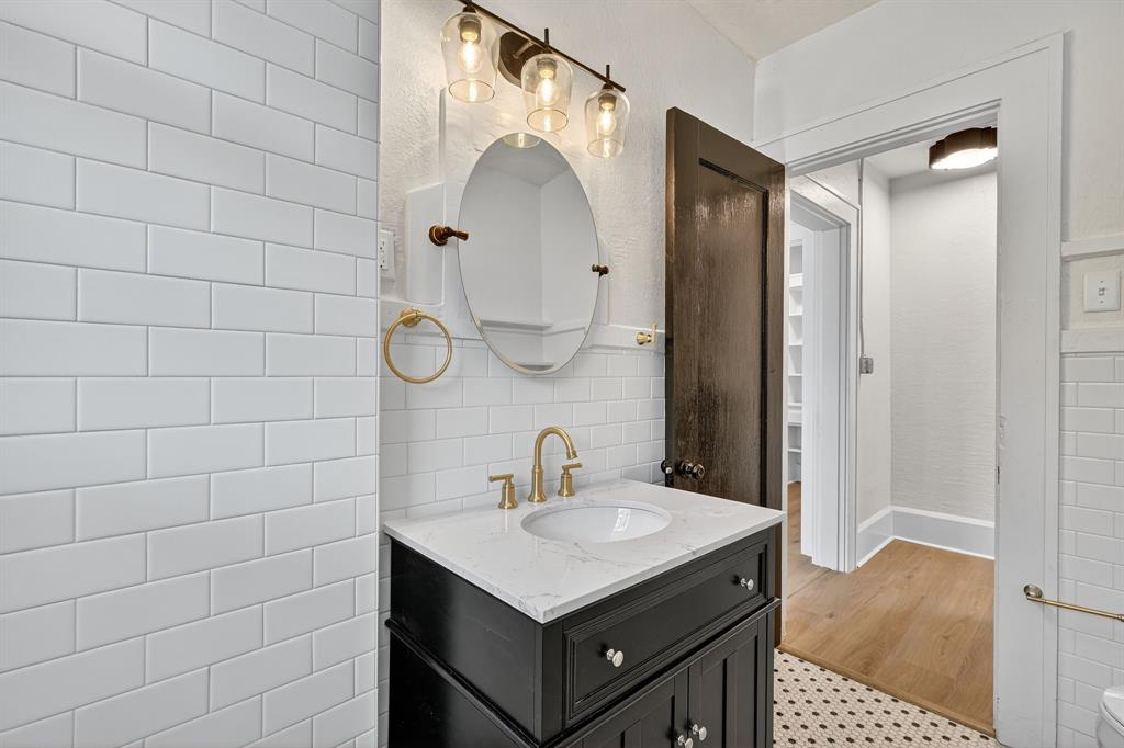 513 Northwest 6th Street, Unit 4 Mineral Wells, TX 76067 - Photo 17 of 34 a bathroom with a sink vanity and a mirror