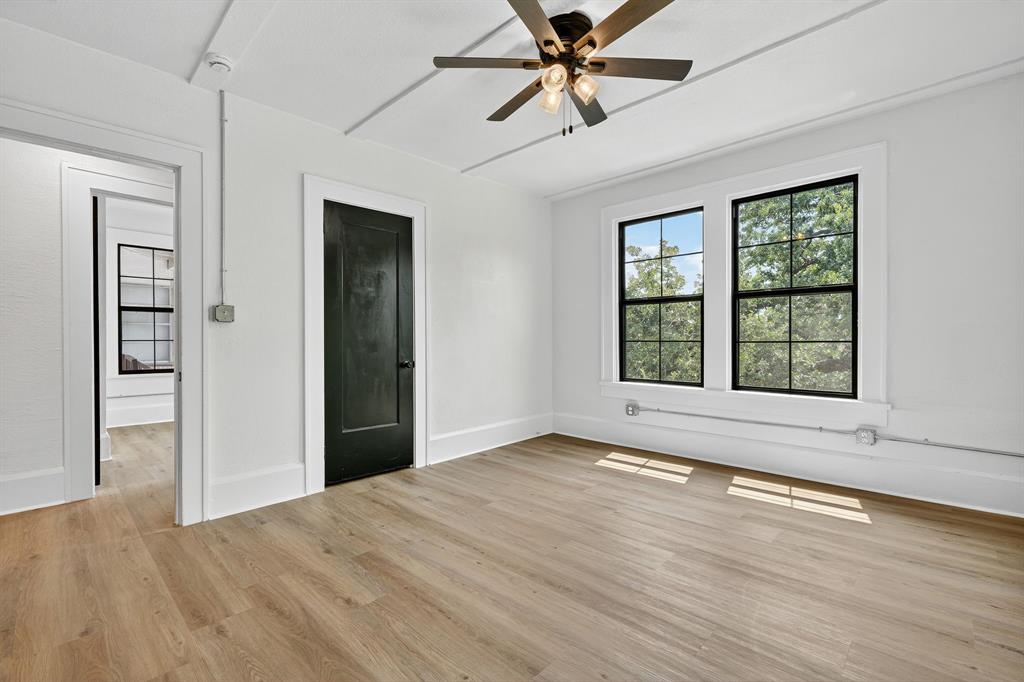 513 Northwest 6th Street, Unit 4 Mineral Wells, TX 76067 - Photo 22 of 34 a view of an empty room with window and wooden floor