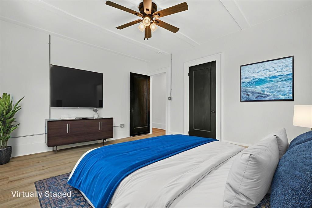 513 Northwest 6th Street, Unit 4 Mineral Wells, TX 76067 - Photo 24 of 34 a bedroom with a bed and a flat screen tv