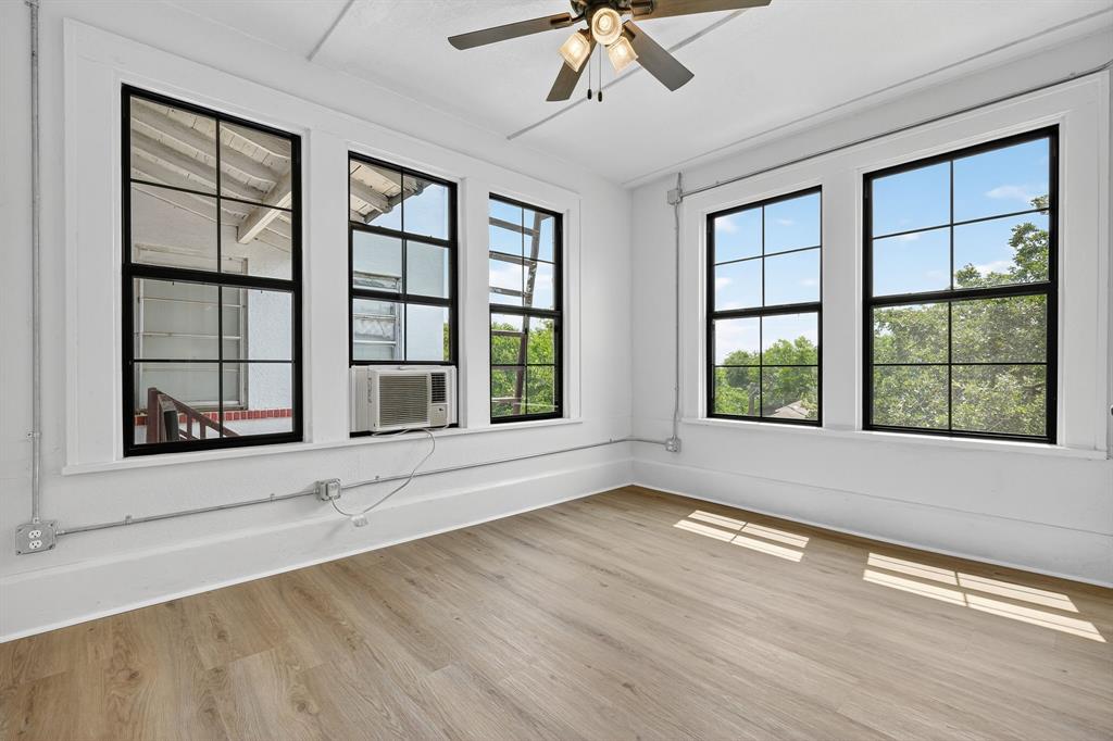 513 Northwest 6th Street, Unit 4 Mineral Wells, TX 76067 - Photo 25 of 34 a view of an empty room with a window and wooden floor