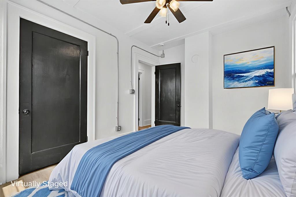 513 Northwest 6th Street, Unit 4 Mineral Wells, TX 76067 - Photo 28 of 34 a bedroom with a bed and a painting on the wall