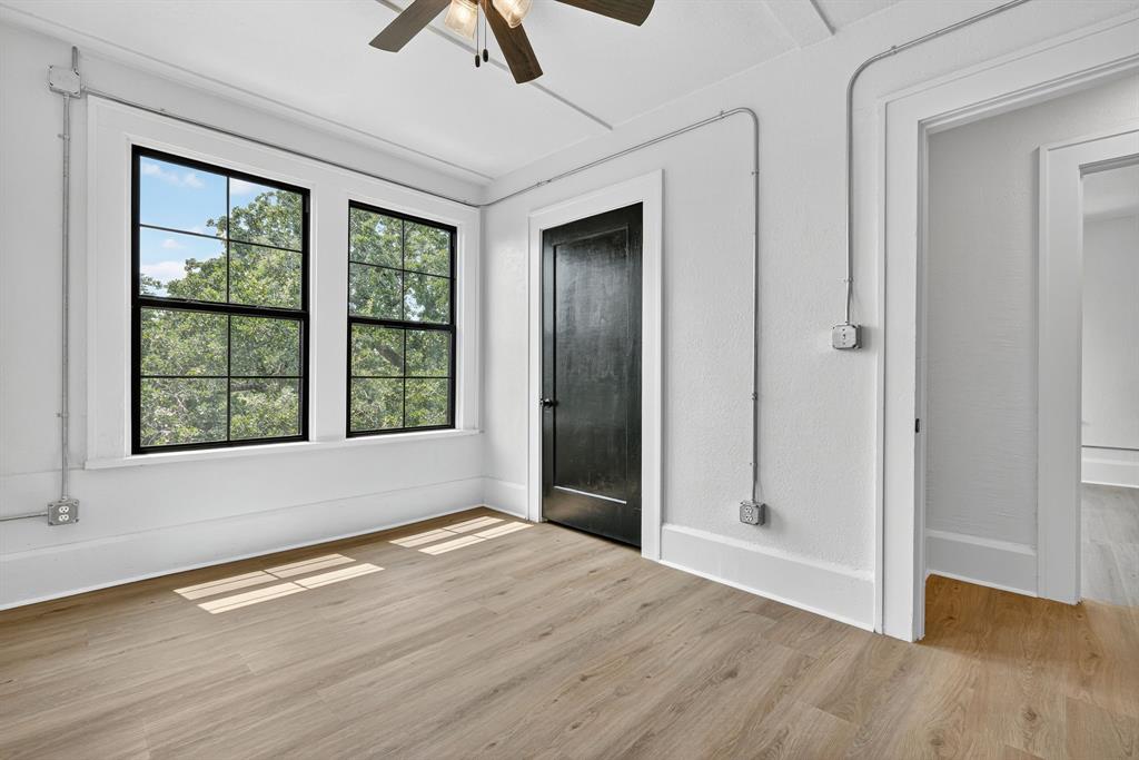 513 Northwest 6th Street, Unit 4 Mineral Wells, TX 76067 - Photo 30 of 34 a view of an empty room with window and wooden floor