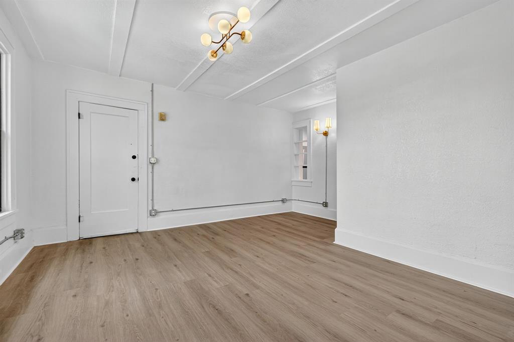 513 Northwest 6th Street, Unit 4 Mineral Wells, TX 76067 - Photo 33 of 34 a view of an empty room with wooden floor
