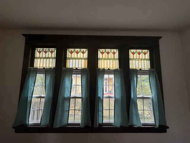 a kitchen with white cabinets and a window