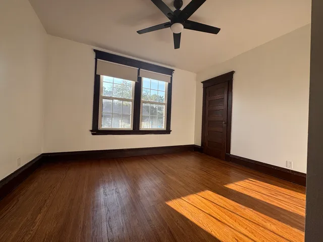 a white toilet sitting next to a small window