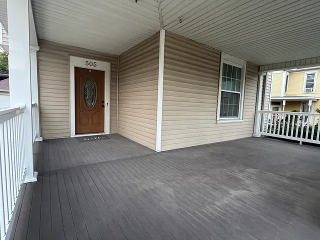 a view of a door and wooden floor