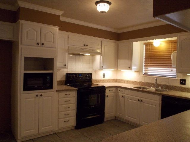 4702 31st Street Lubbock, TX 79410 - Photo 3 of 10 a kitchen with a sink stove and microwave