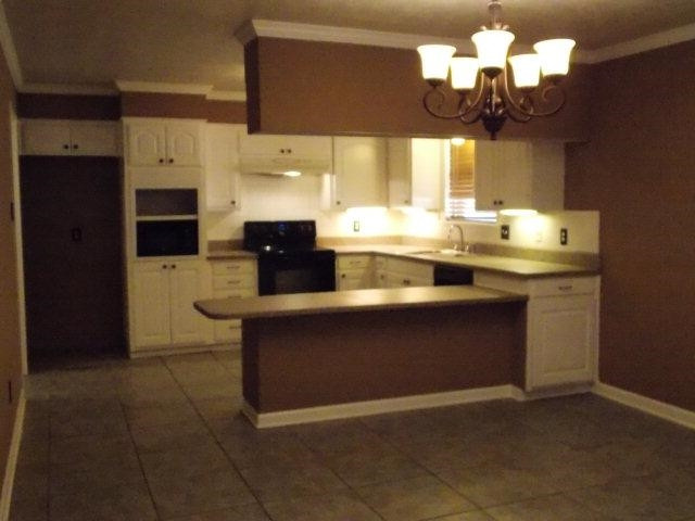 4702 31st Street Lubbock, TX 79410 - Photo 4 of 10 a kitchen with a sink and cabinets