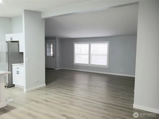 a view of an empty room and a window