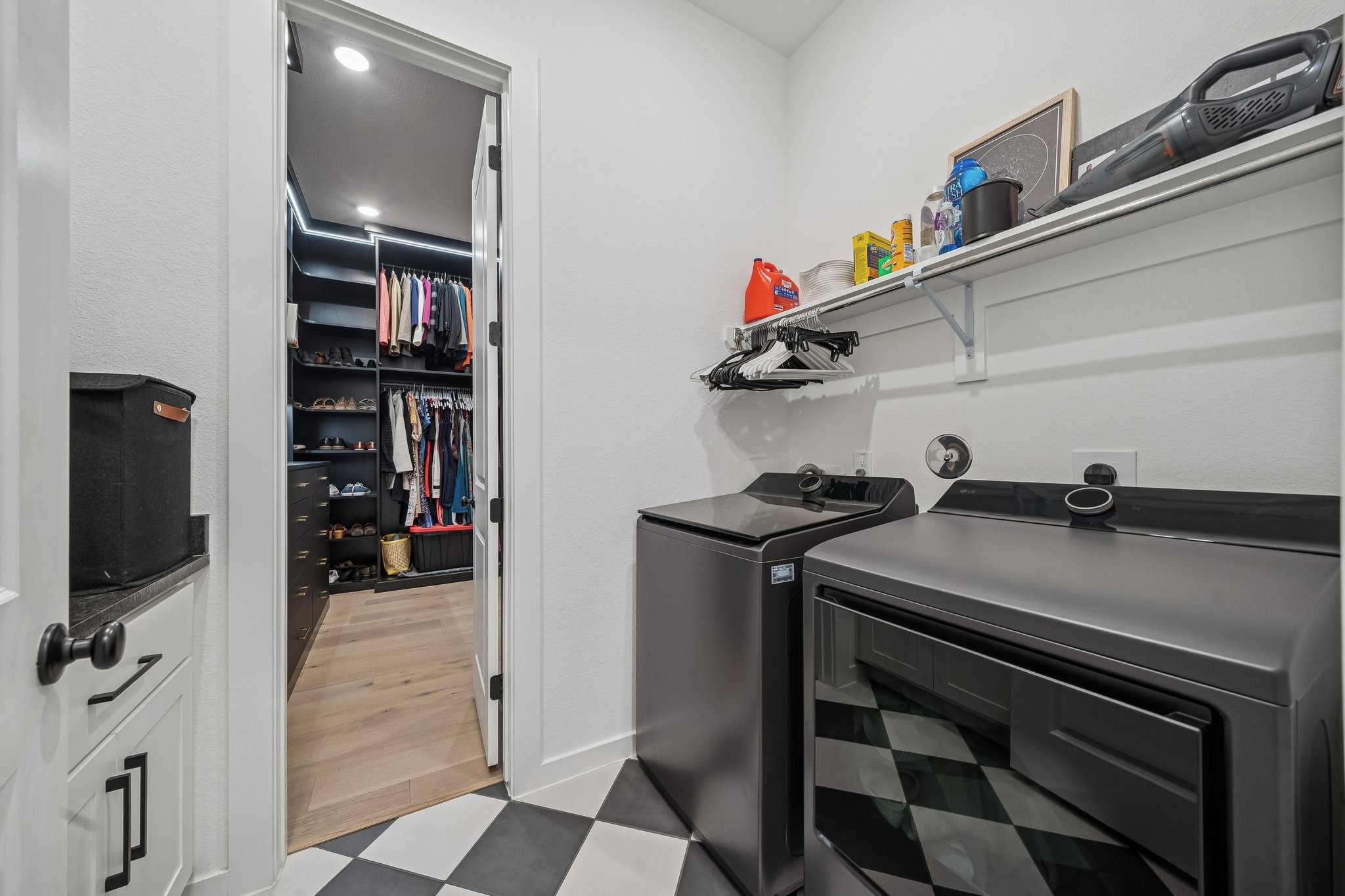 8703 Blue Grotto Lane Manvel, TX 77578 - Photo 19 of 43 The laundry room with fashionable checkered floor, connects to the hall AND the primary closet.