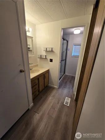 a view of bathroom with a sink and mirror