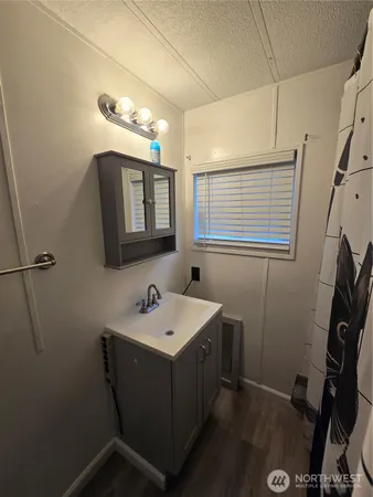 a bathroom with a sink a mirror and a toilet