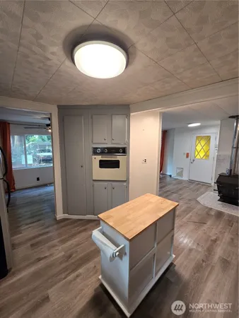 a kitchen with kitchen island a sink dishwasher a stove and a refrigerator with wooden floor