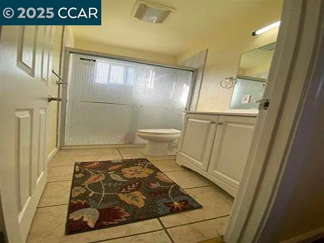 a bathroom with a double vanity sink toilet and shower