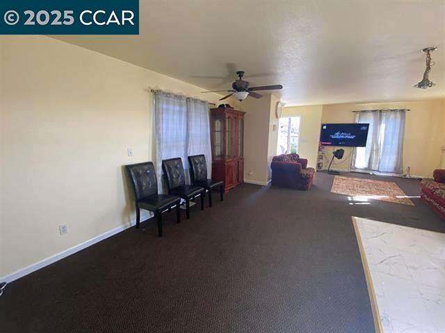 150 Rodeo Avenue Rodeo, CA 94572 - Photo 3 of 20 a living room with furniture and a chandelier