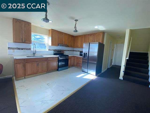 150 Rodeo Avenue Rodeo, CA 94572 - Photo 5 of 20 a kitchen with stainless steel appliances granite countertop a sink a stove and a refrigerator