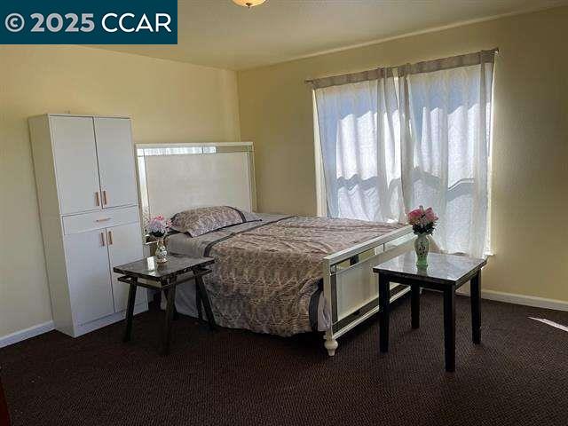 150 Rodeo Avenue Rodeo, CA 94572 - Photo 7 of 20 a bedroom with a table chair and a window