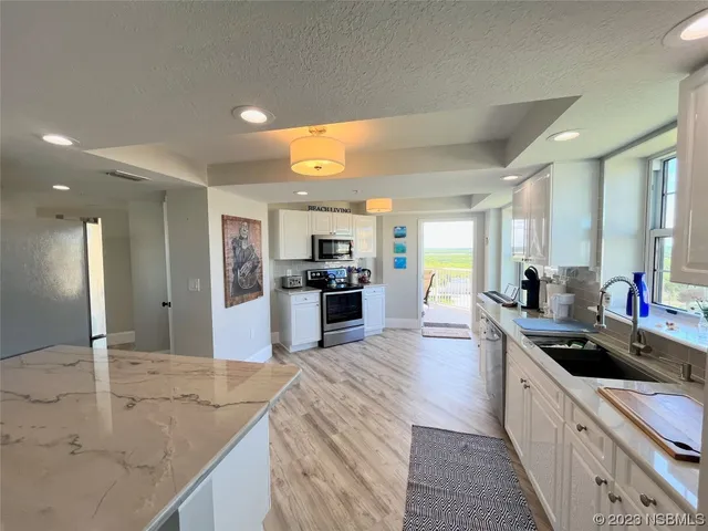 a living room with fireplace furniture and a chandelier