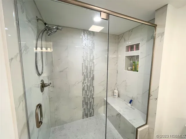 a view of a hallway with wooden floor and entryway
