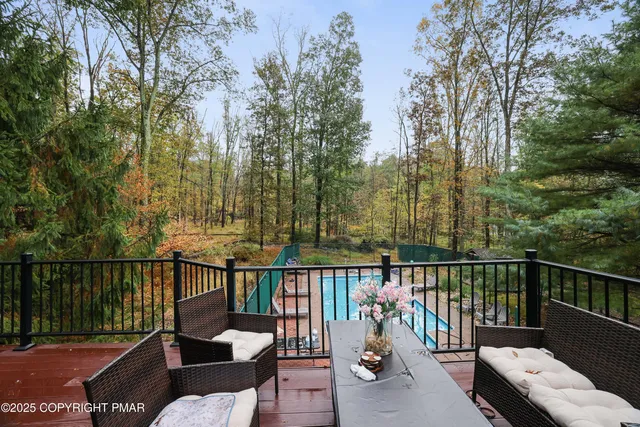 a view of a roof deck with wooden floor and fence