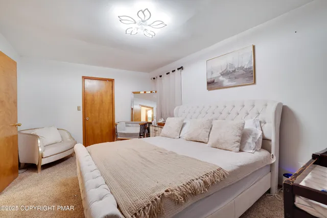 a bedroom with a bed and a couch